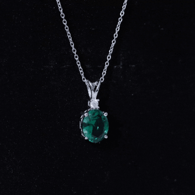 Oval Created Emerald and Moissanite Solitaire Pendant