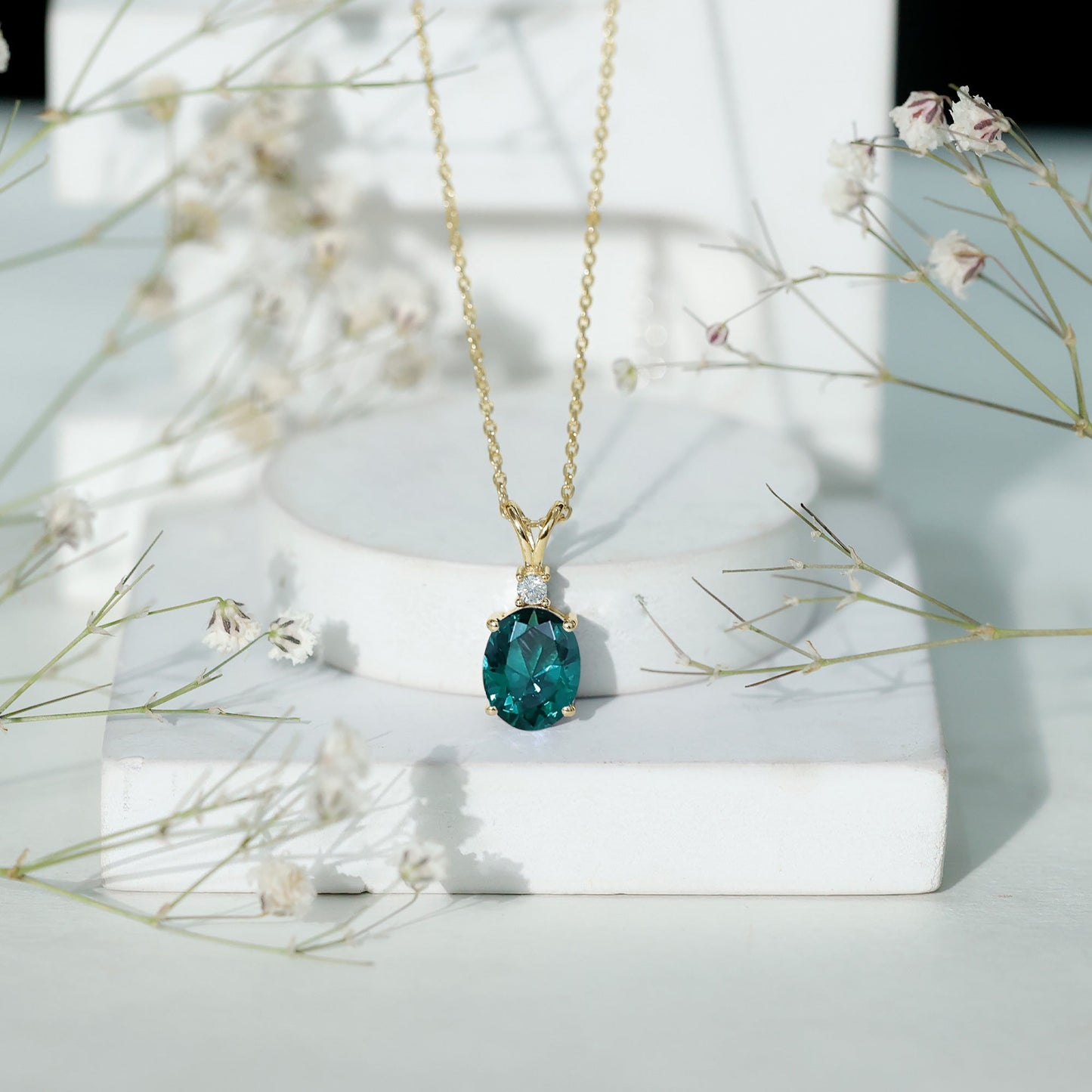 Oval Created Emerald and Moissanite Solitaire Pendant