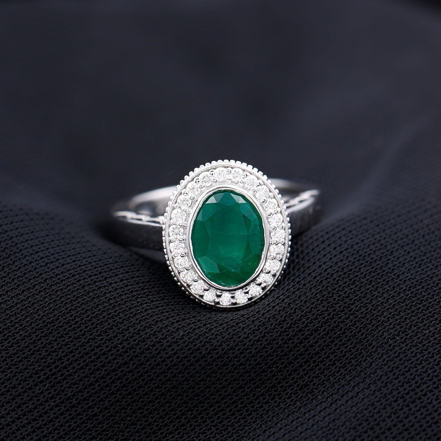 1.2 Carat Oval Lab Grown Emerald Bezel Set Engagement Ring With Diamond Halo