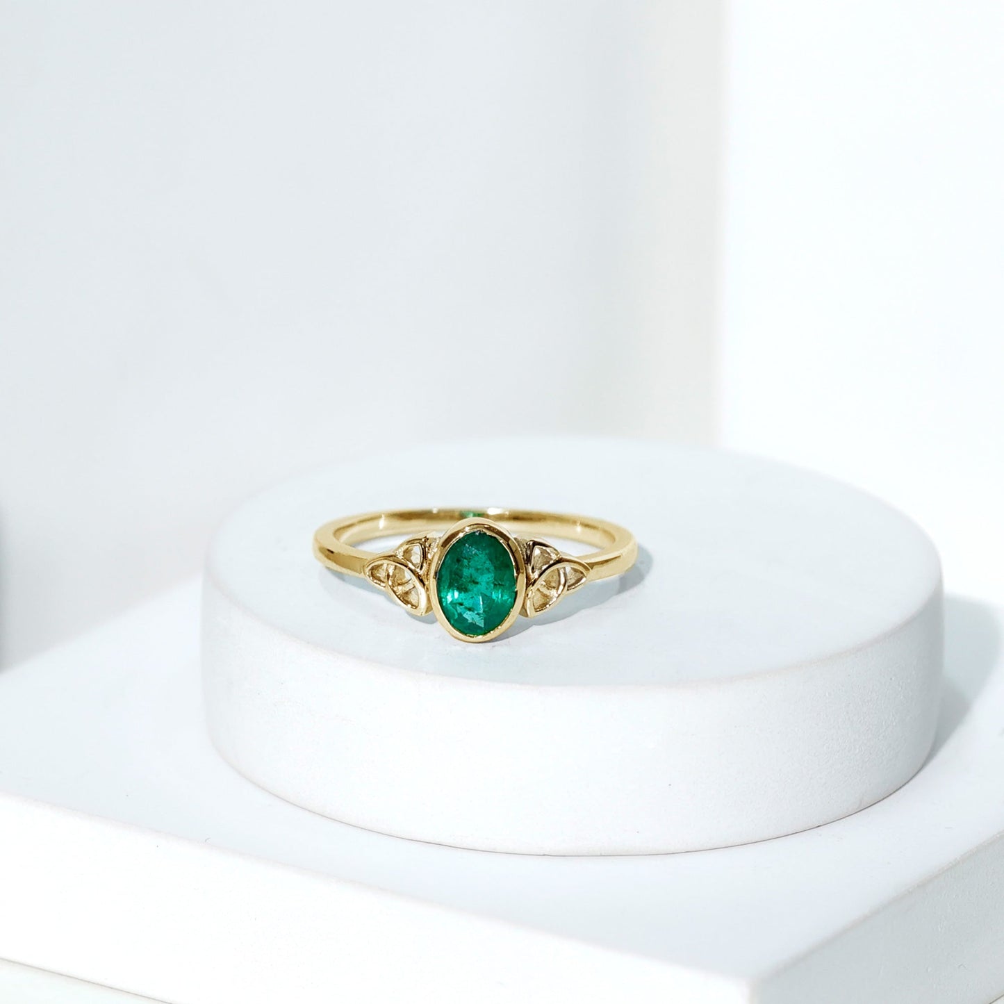 Oval Shaped Emerald Celtic Engagement Ring in Bezel Setting