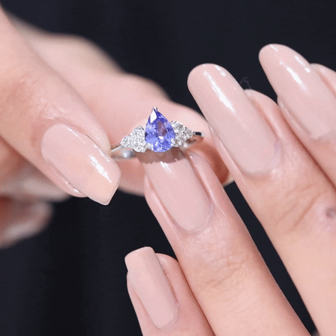 0.8 Carat Pear Shaped Tanzanite Engagement Ring with Diamond Trio