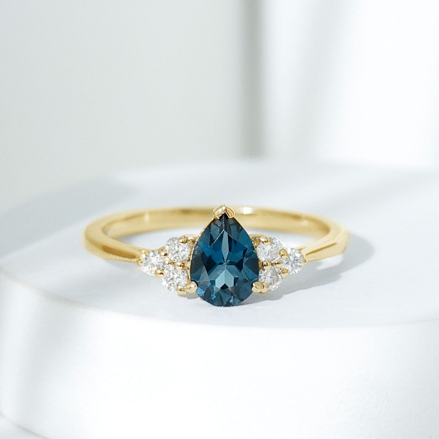 5X7mm Pear Shape London Blue Topaz Engagement Ring with Diamond Trio