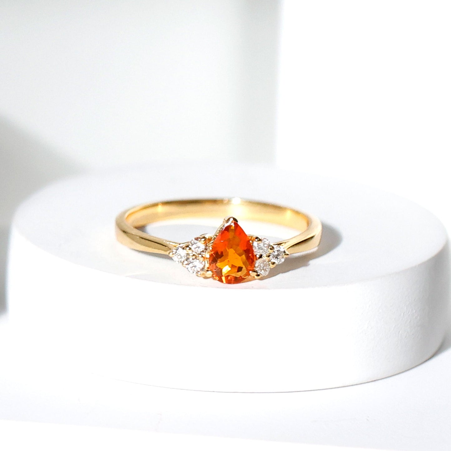 0.6 Carat Pear Shaped Fire Opal Engagement Ring with Diamond Trio