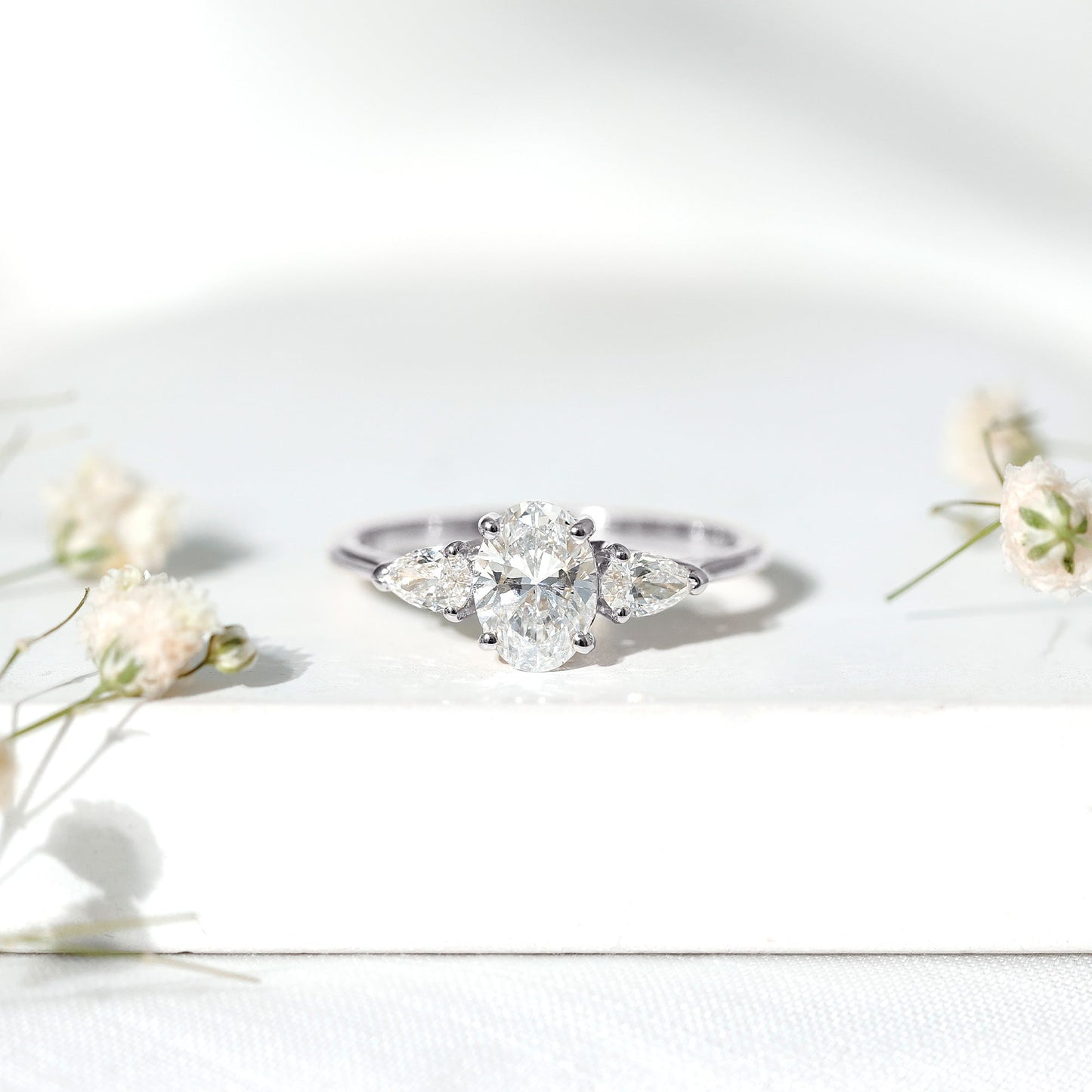 Oval and Pear Cut Moissanite Three Stone Engagement Ring