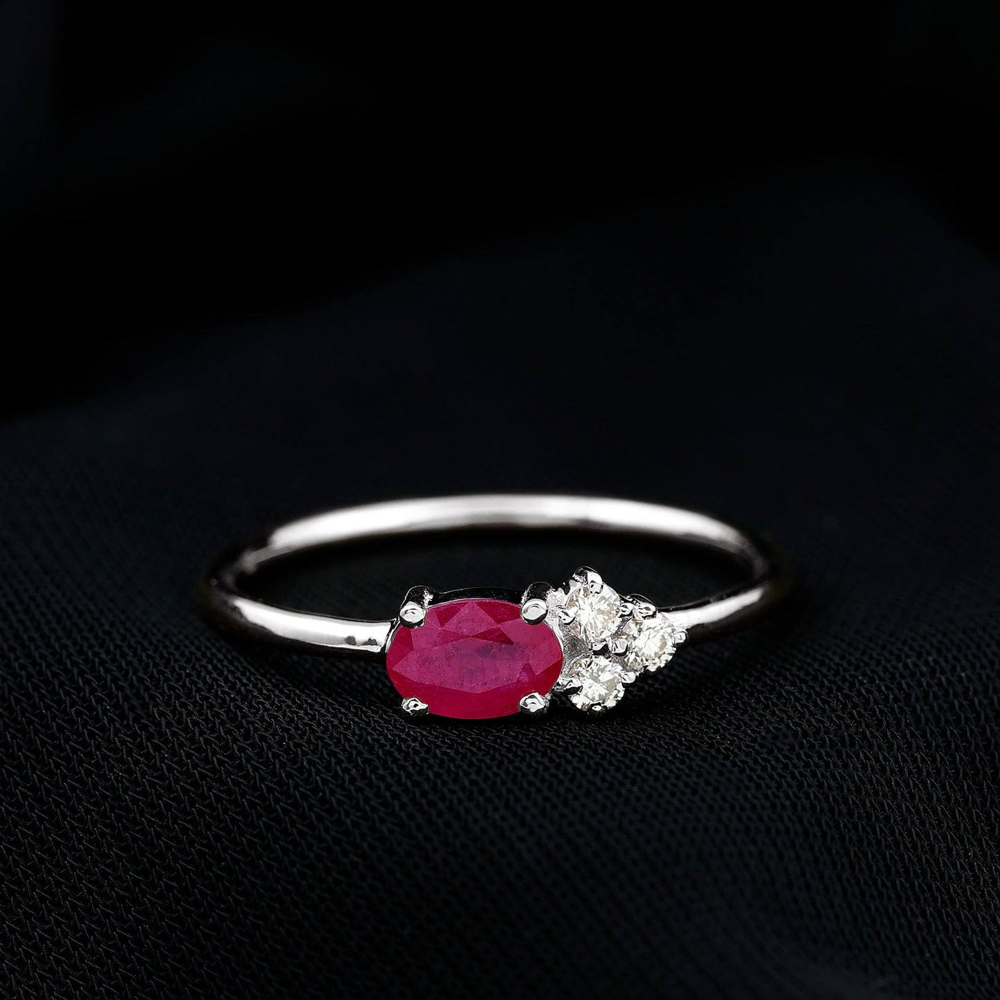 East West Style 0.6 Carat Oval Ruby Promise Ring with Diamond Trio
