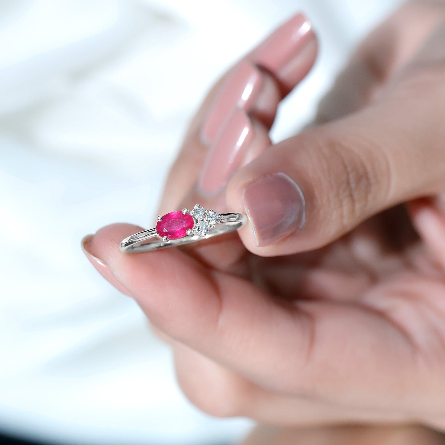 East West Style 0.6 Carat Oval Ruby Promise Ring with Diamond Trio