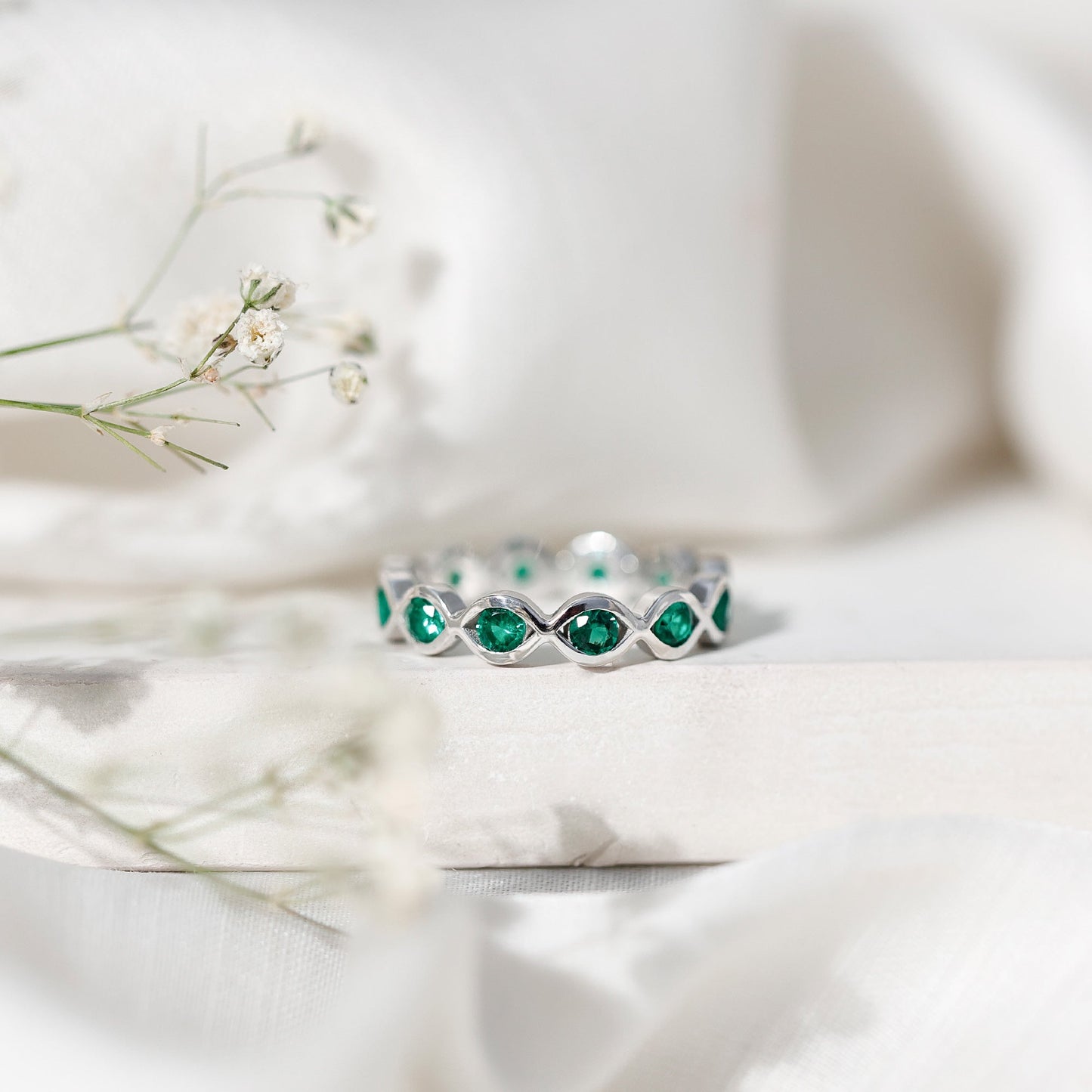 Certified Lab Grown Emerald Infinity Twisted Eternity Ring