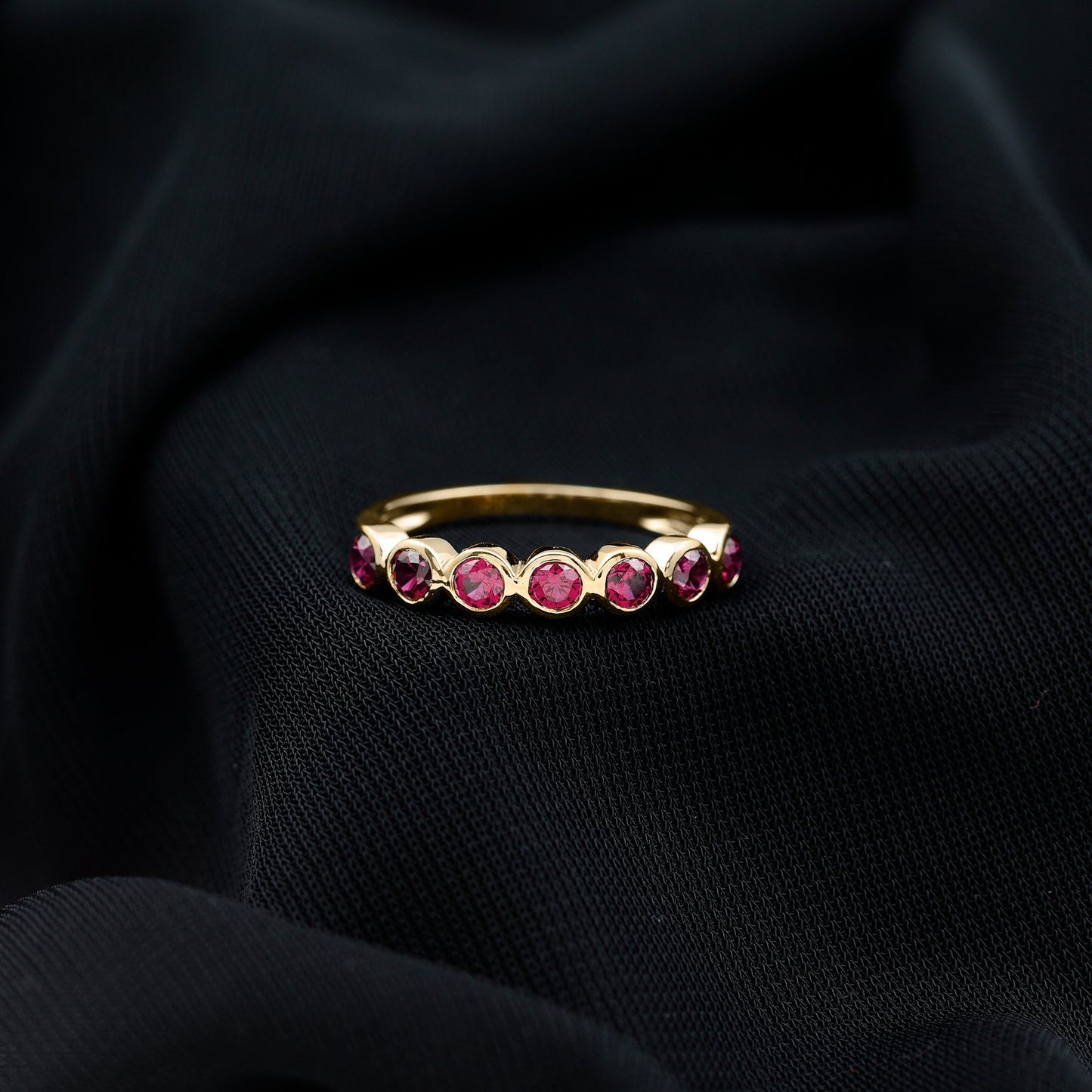 Minimal Created Ruby Half Eternity Ring in Bezel Setting