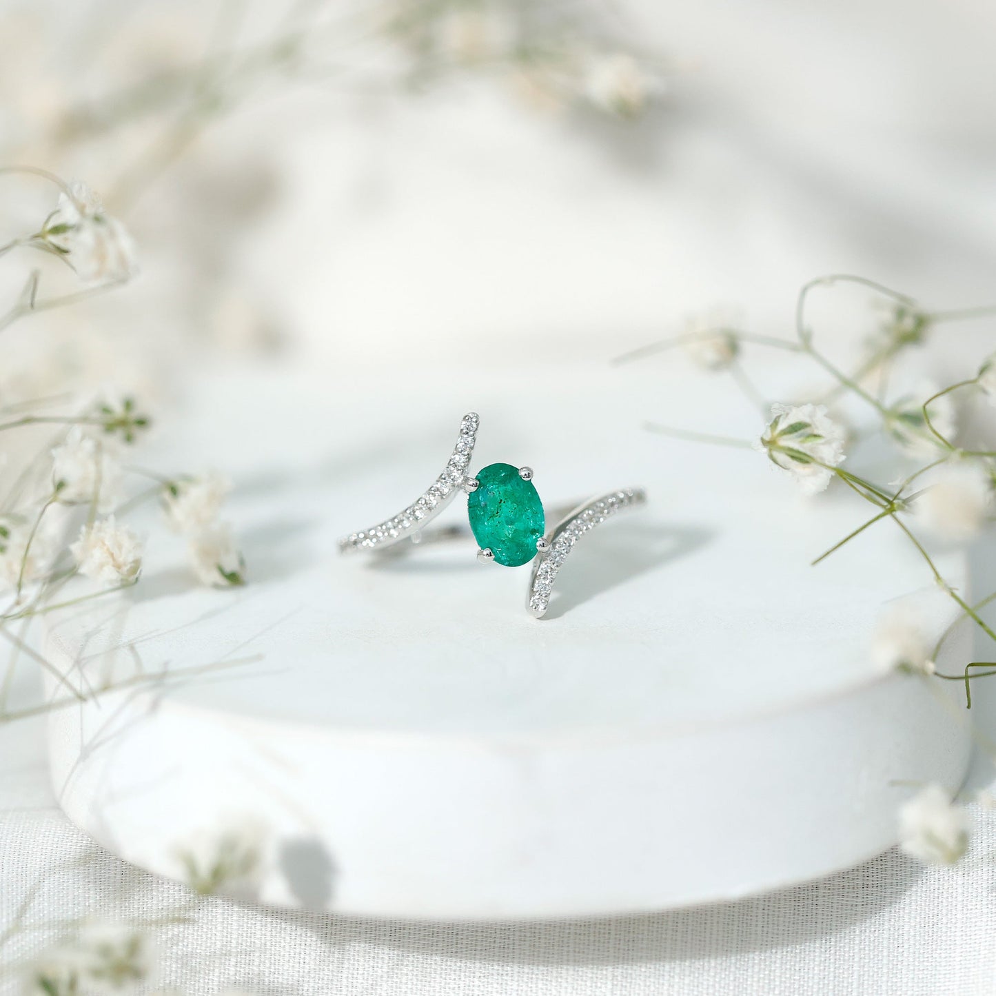 Oval Shaped Emerald Bypass Engagement Ring with Diamonds