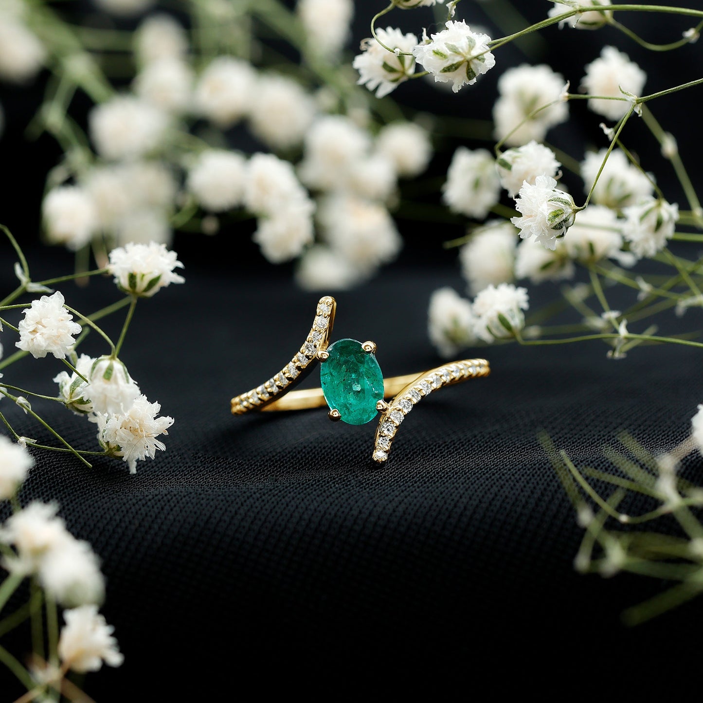 Oval Shaped Emerald Bypass Engagement Ring with Diamonds