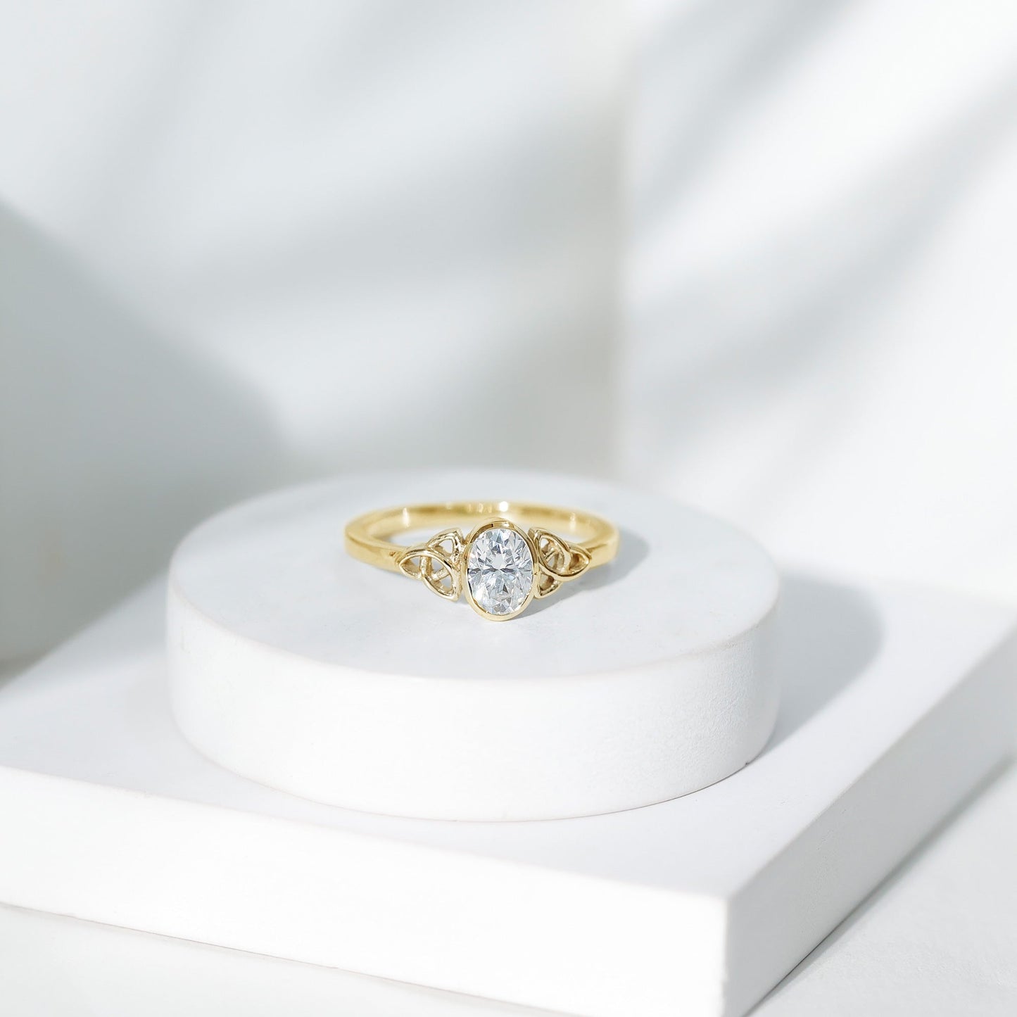 Oval Moissanite Solitaire Celtic Knot Ring in Bezel Setting