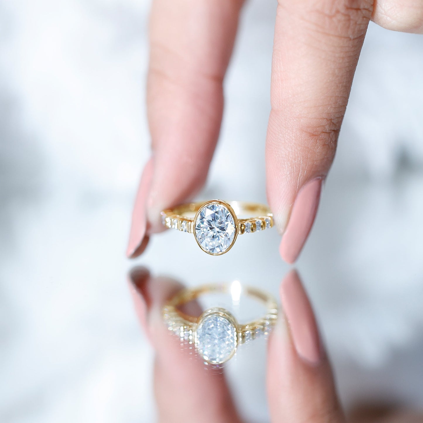 Bezel Set Moissanite Oval Engagement Ring with Side Stones