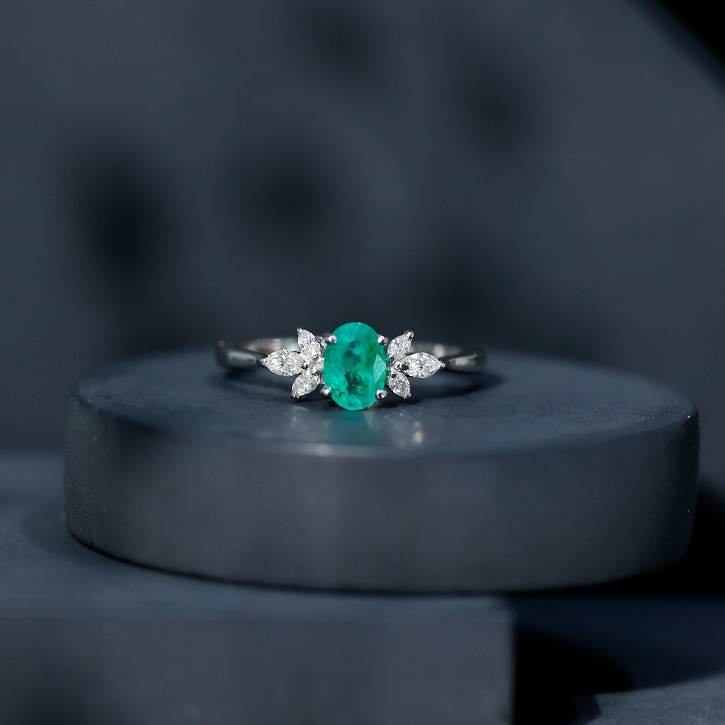 Oval Shaped Emerald Engagement Ring with Marquise Diamond Trio