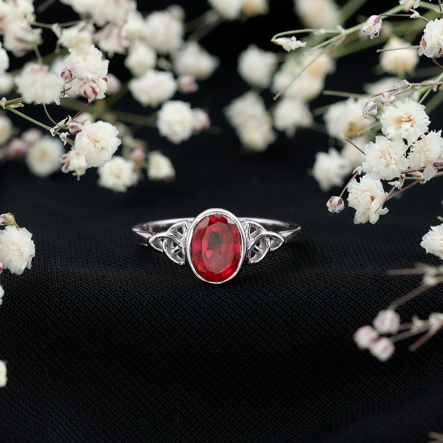 Oval Shaped 1.5 Carat Lab Grown Ruby Celtic Engagement Ring in Bezel Setting