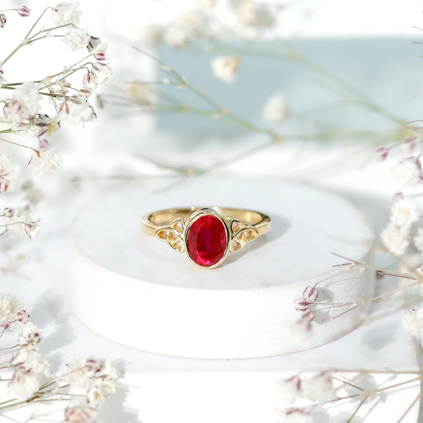 Oval Shaped 1.5 Carat Lab Grown Ruby Celtic Engagement Ring in Bezel Setting